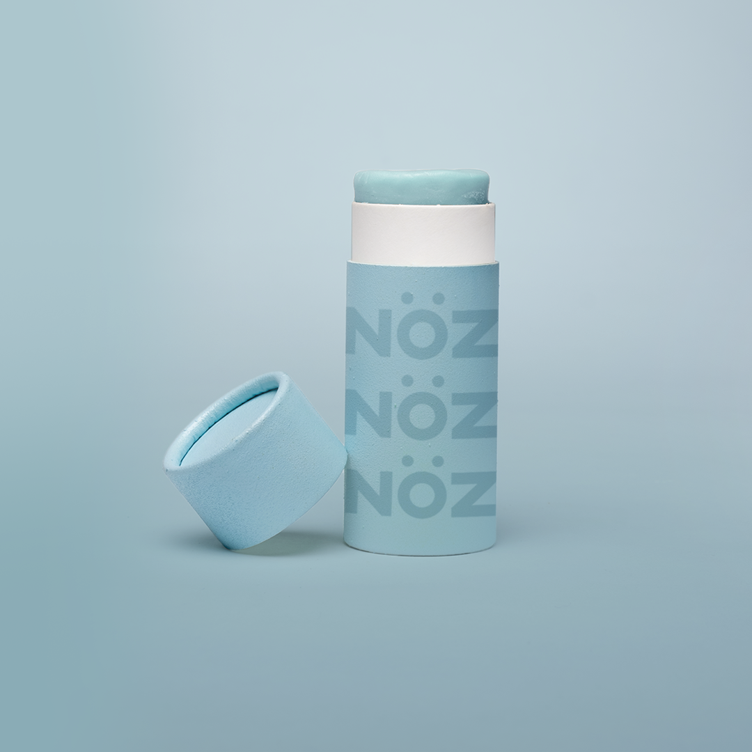 A blue bottle of our affordable, eco-friendly, and vegan Noz Sunscreen with our logo on the bottle.