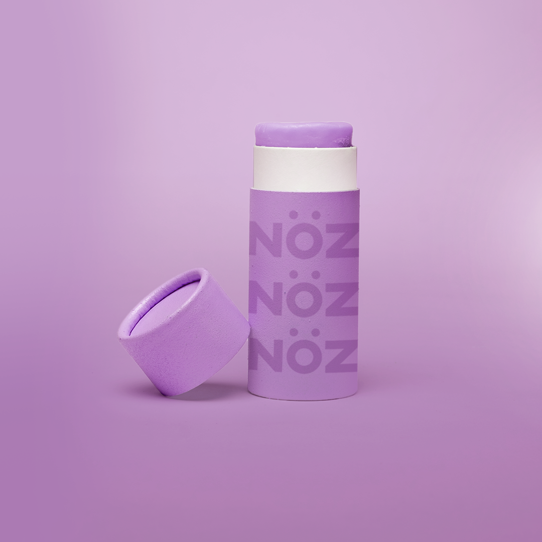 A purple bottle of our affordable, eco-friendly, and vegan Noz Sunscreen with our logo on the bottle.