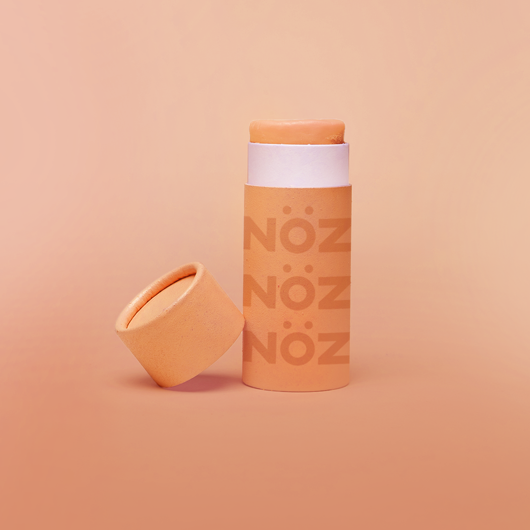 A orange bottle of our affordable, eco-friendly, and vegan Noz Sunscreen with our logo on the bottle.