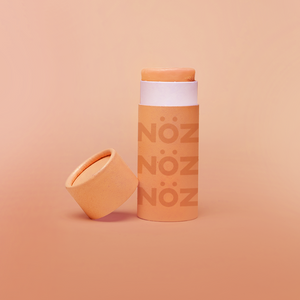 A orange bottle of our affordable, eco-friendly, and vegan Noz Sunscreen with our logo on the bottle.