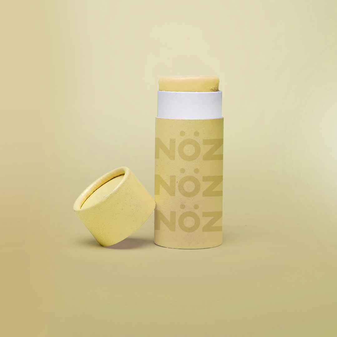 A yellow bottle of our affordable, eco-friendly, and vegan Noz Sunscreen with our logo on the bottle.